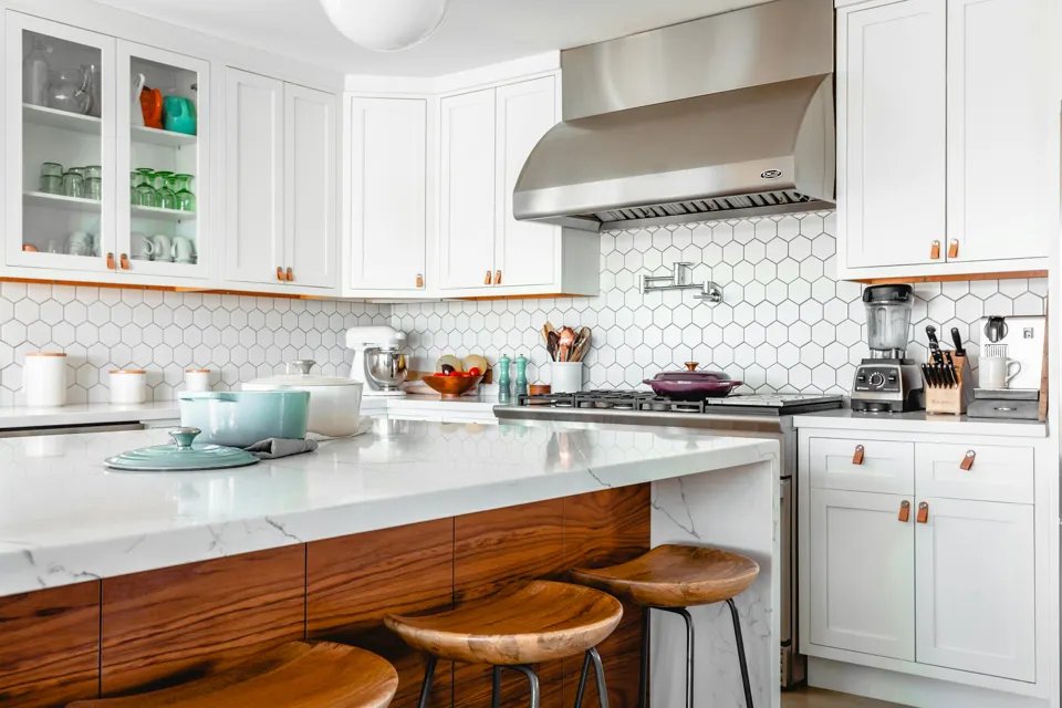 Bright kitchen with white cabinetry and warm timber details