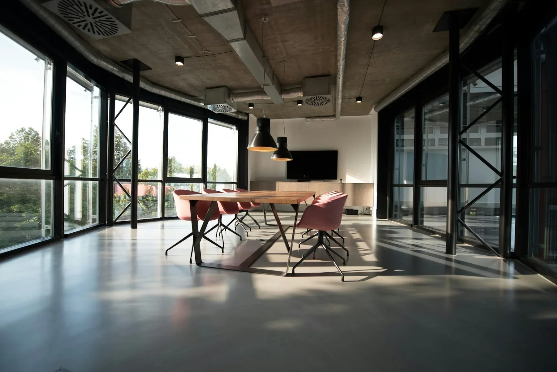 Open-plan workplace with large windows and modern furnishings